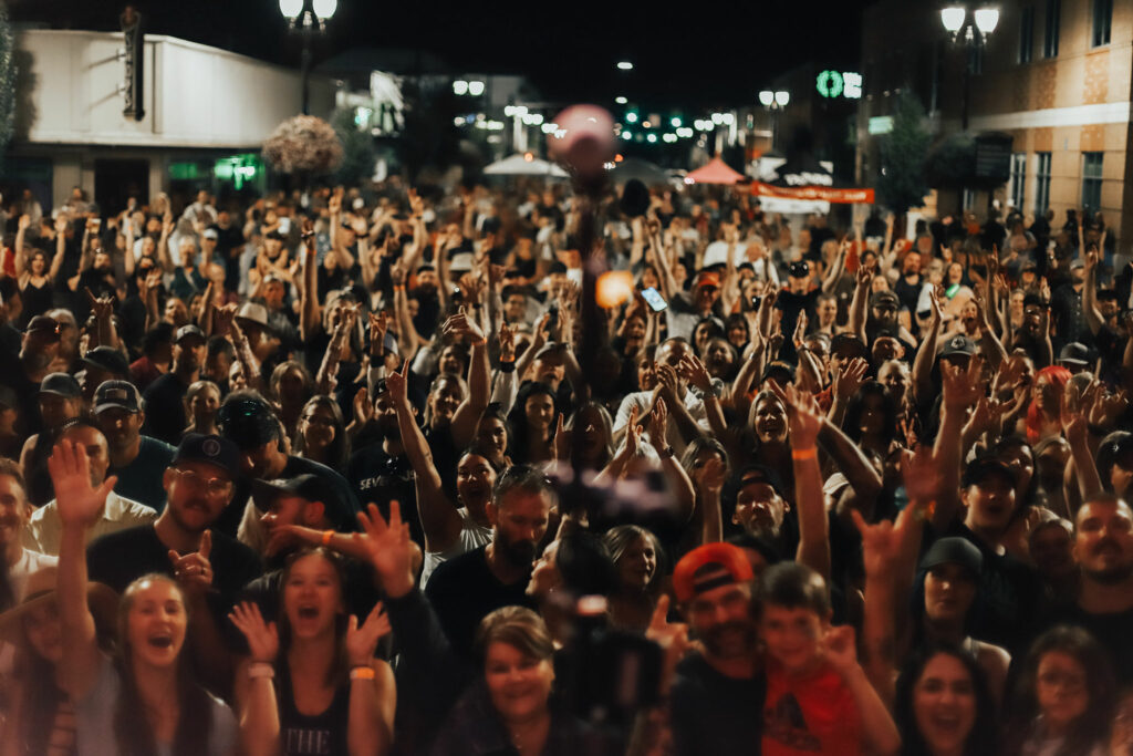 A crowd at night time listening to live music.