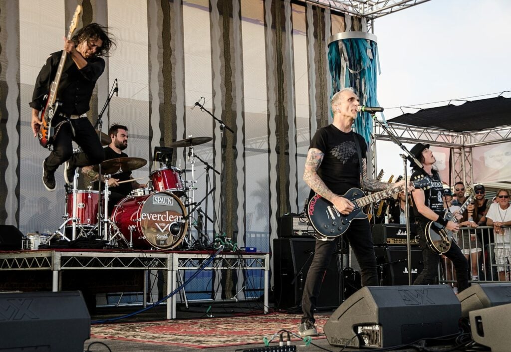 The band members of Everclear on stage playing a song.