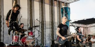 The band members of Everclear on stage playing a song.