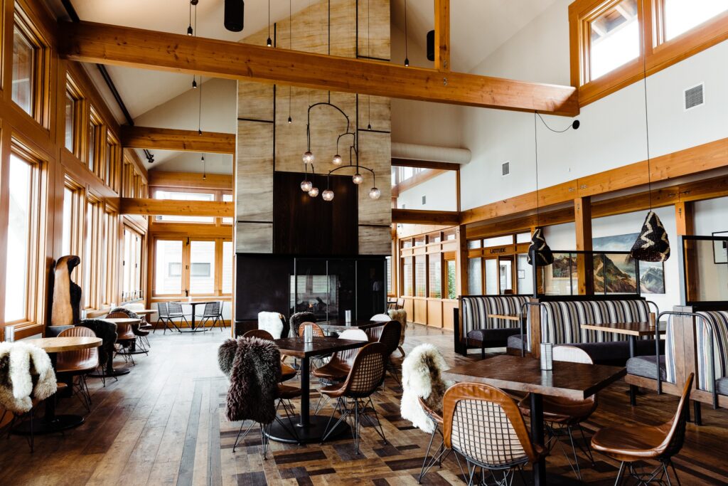 The Meridian Restaurant. It has high ceilings, stylish black furniture, wooden beams near the ceiling and cool light fixtures.