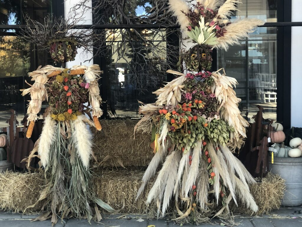 Two unique looking scarecrows.