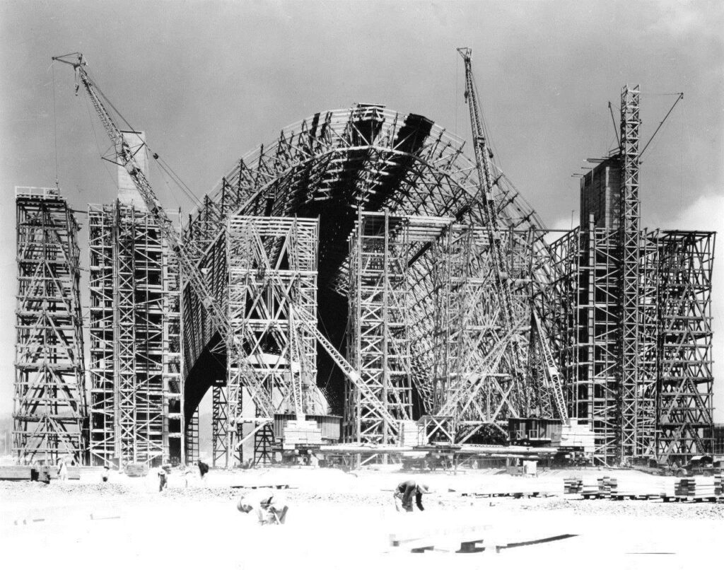 A black and white photo of a massive air hangar being constructed. tillamook air museum, planes, WWII, history, family things to do, oregon coast