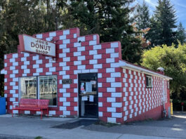 The exterior of Joe's Donuts in Sandy, Oregon. The building is red and white checkered bricks.