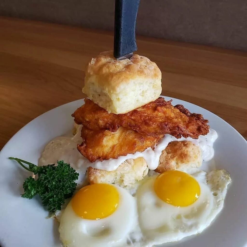 Chicken and biscuits with eggs and gravy.