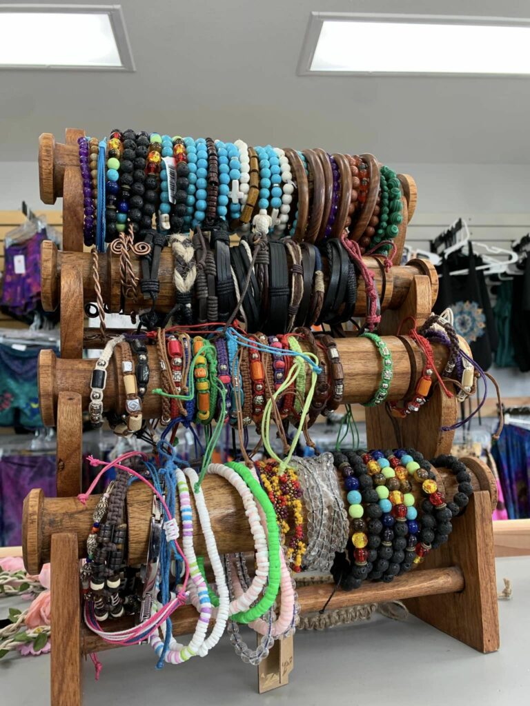 A variety of bracelets and beaded bracelets in blues, greens, browns, blacks, and other colors.