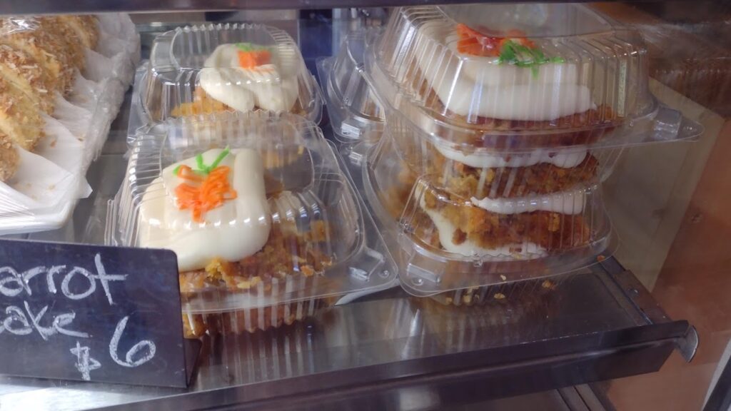 Clear plastic takeout containers with carrot cake. Looks tasty!