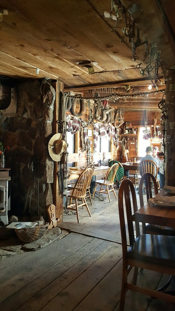 The rustic interior of The Cowboy Dinner Tree. There are cowboy decorations all over the walls.