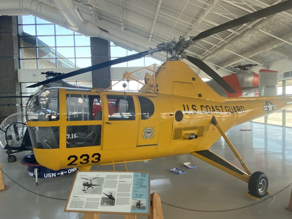 A yellow helicopter inside the Evergreen Aviation And Space Museum.