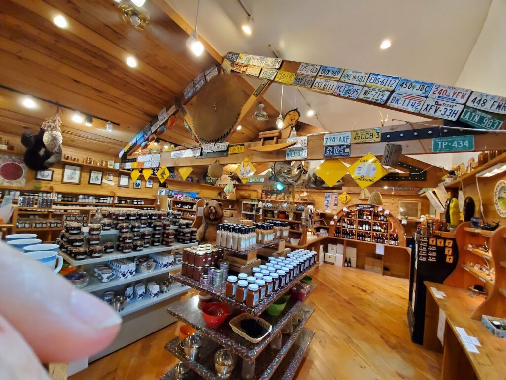 The interior of the store. It's all wood and looks like a cute wood cabin inside. There are shelves and shelves (all wood) packed with homemade jams and jellies. The wooden rafters are covered in license plates from various states. It's a super cute store!