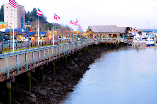 Coos Bay Boardwalk. There are American flags along the boardwalk.