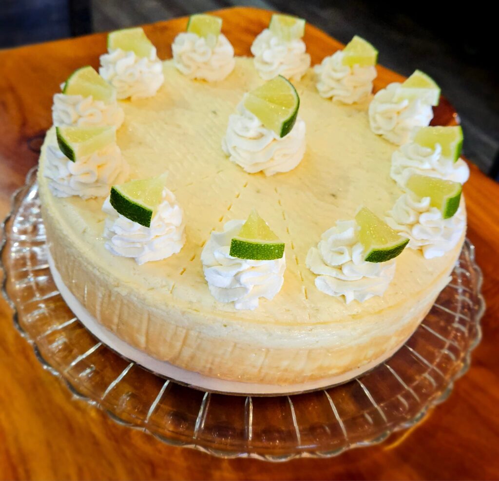 Lime cheesecake. This thing looks so amazing. It's got spots of frosting piped on top, and on top of each dollop of frosting is a wedge of lime.