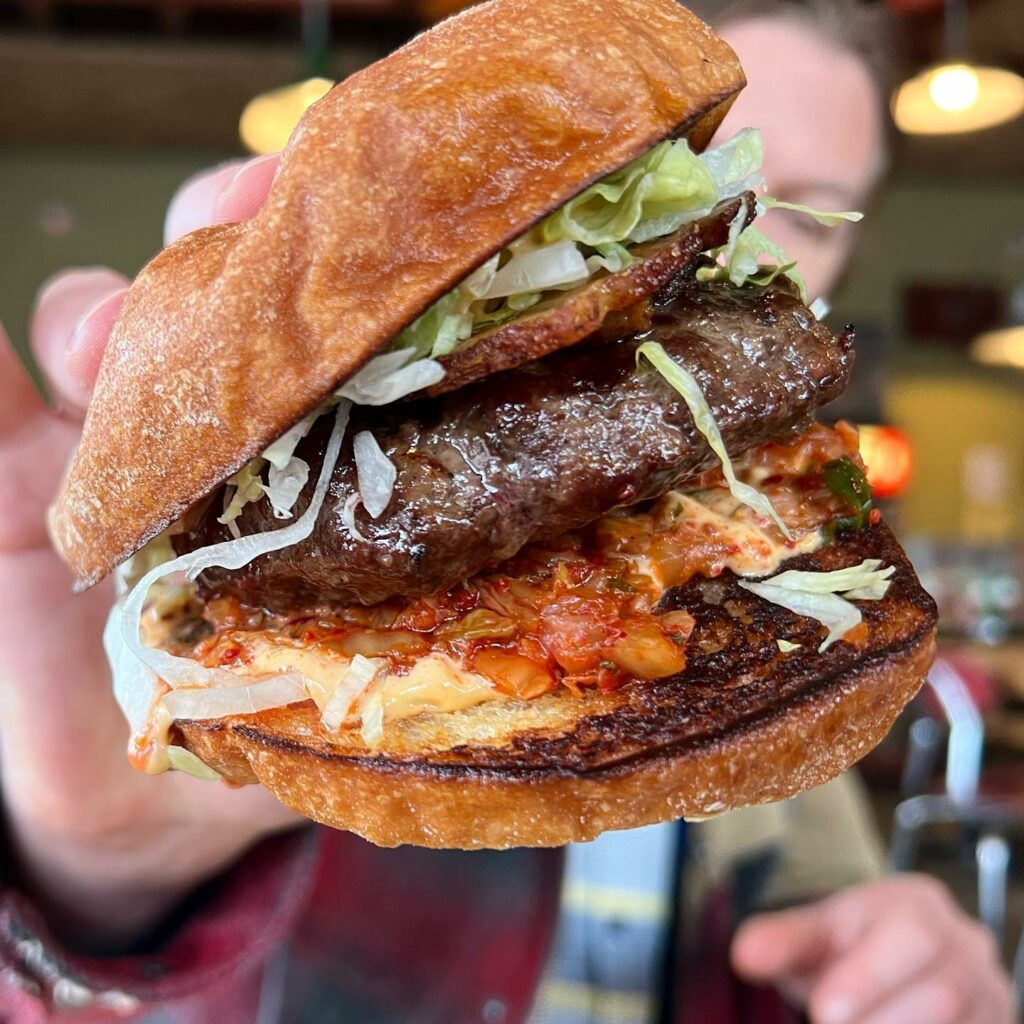 A massive mouthwatering burger from Ate-Oh-Ate.
portland oregon, best restaurants, 2024, where to eat, best brunch, food and drink, bars, pizza, sushi, thai food, PDX, foodie heaven