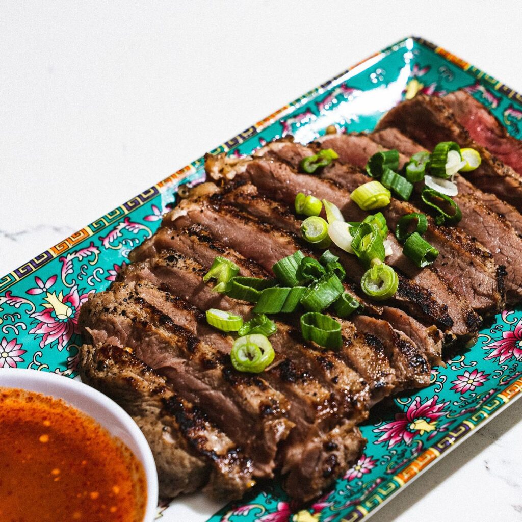 Delicious looking cooked steak with chives on top and a bowl of red sauce.
portland oregon, best restaurants, 2024, where to eat, best brunch, food and drink, bars, pizza, sushi, thai food, PDX, foodie heaven