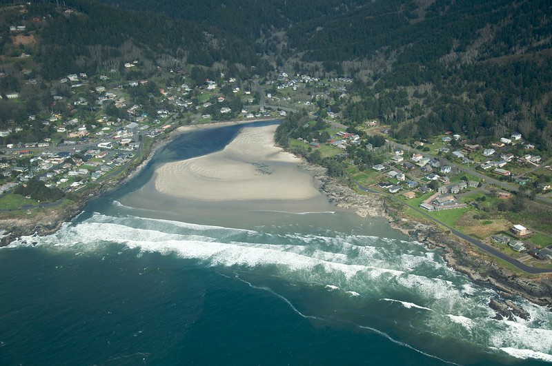 Yachats as seen by air. The Yachats River can be seen going through the center of town and out into the ocean, best oregon towns, spring road trip, best towns to visit, 2024