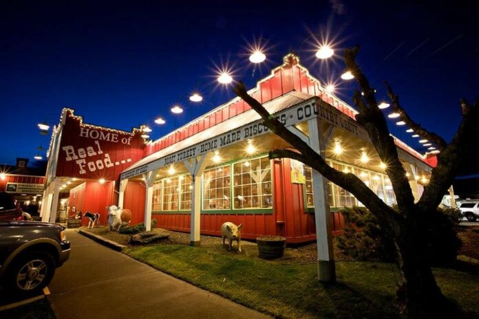 The exterior of Cousins' Restaurant in The Dalles Oregon. It's a red barn style building with white trim. It looks very cute.