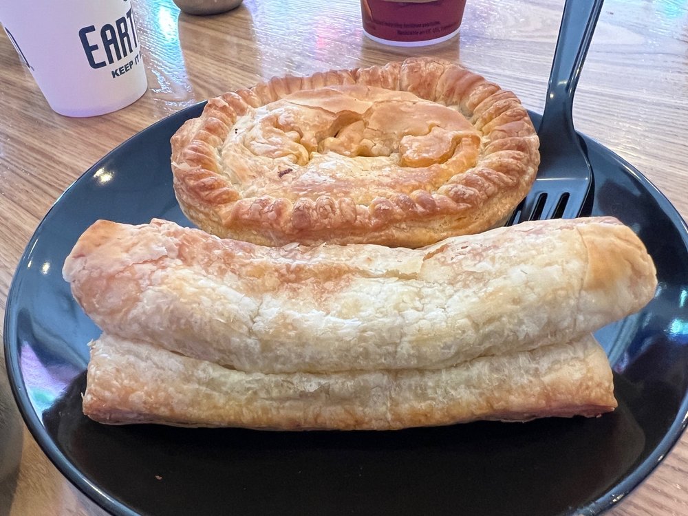 A meat pie on a black plate.