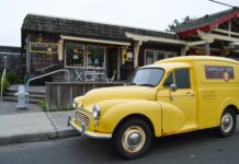 The outside of the Cannon Beach Café. There's an old vintage yellow delivery truck parked out front.