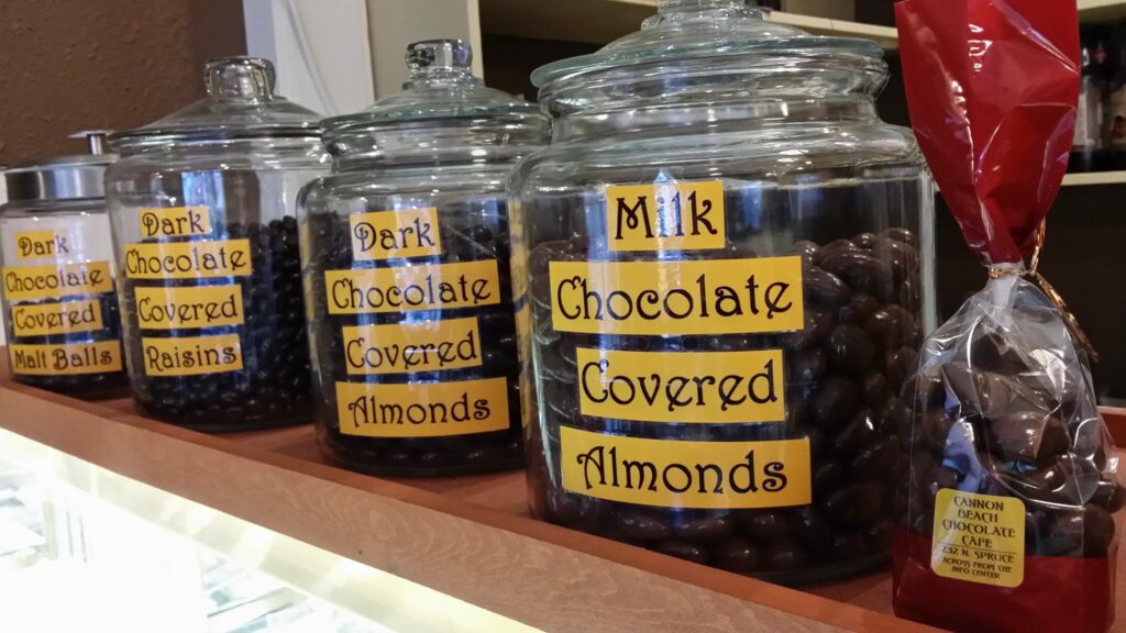 Glass jars of chocolate covered almonds.