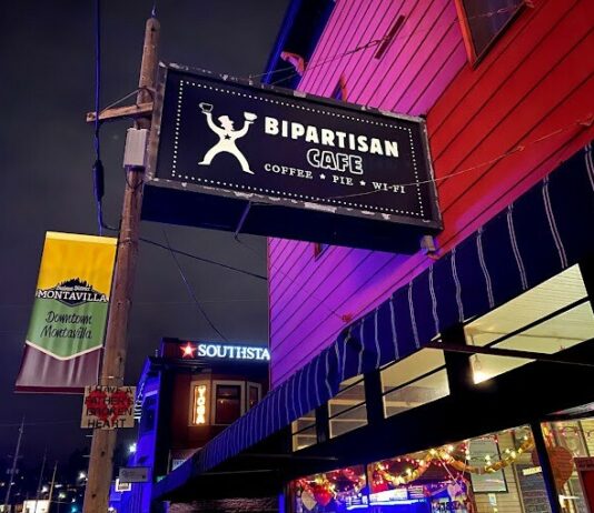 The outside of the Bipartisan Cafe at night.