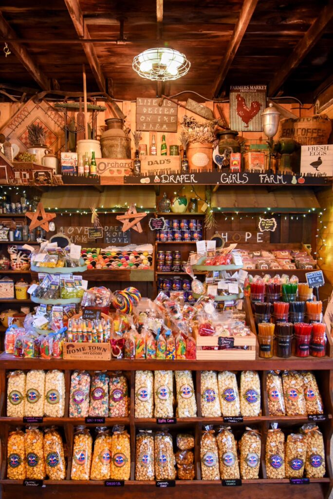 The inside of the Draper Girls Country Farm store. There's bags of popcorn, honey sticks, candy, and farm décor.