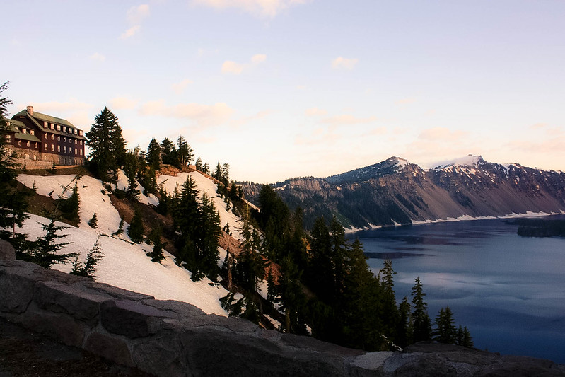 The lodge looks tiny as it sits on a snow covered rim overlooking the massive Crater Lake.