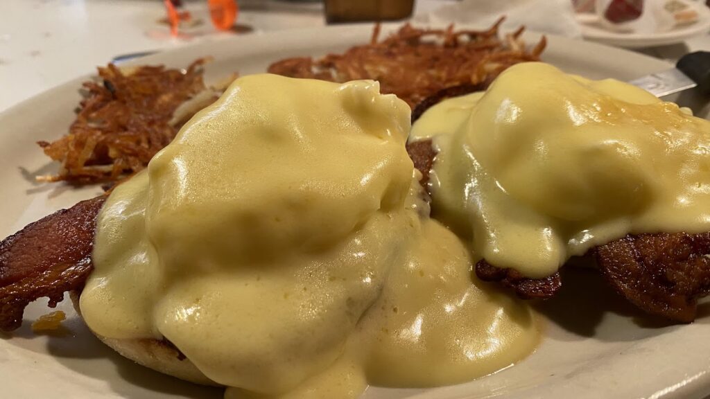 Eggs benedict with hash browns.
