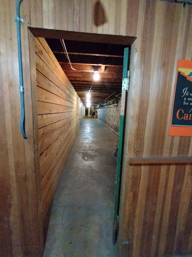 A long narrow tunnel with wooden walls and a wooden ceiling on the under ground tour.