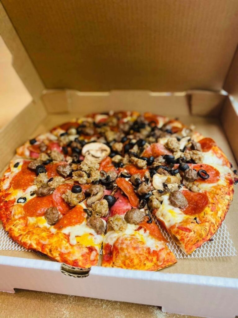 A delicious looking pizza in a pizza box.