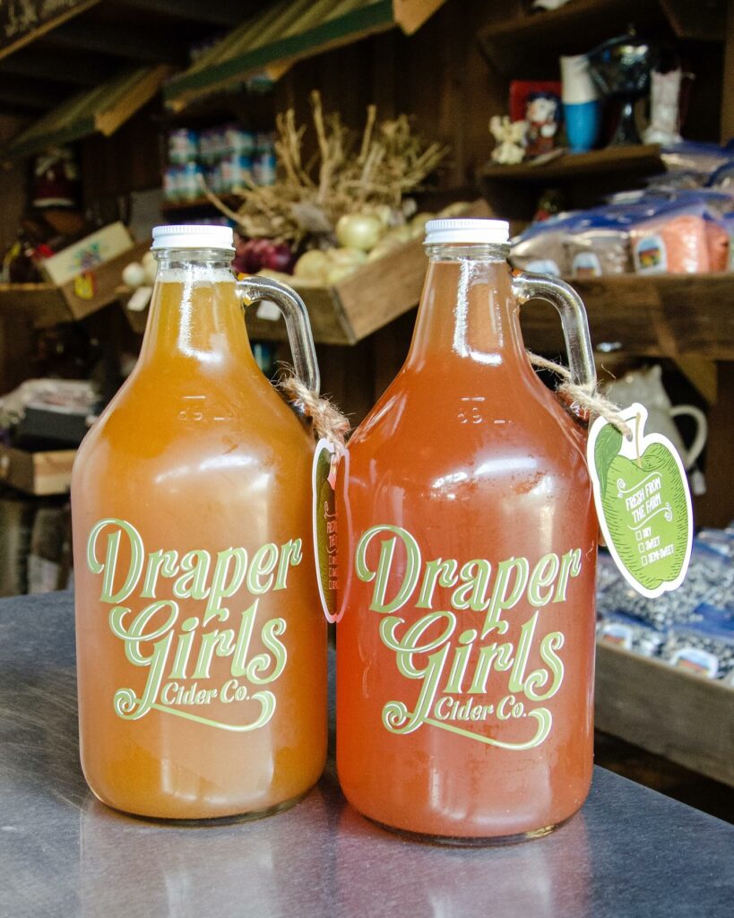 Two glass bottles of hard cider at the Draper Girls Country Farm store.
