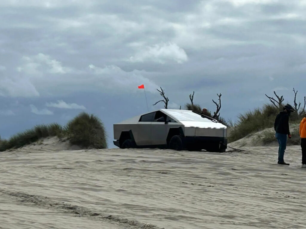 A Tesla Cybertruck stuck in the sand dunes on the Oregon Coast.