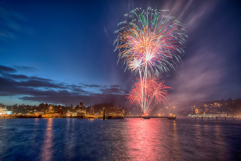 Fireworks over Newport, Oregon. The colorful light reflects in the water.