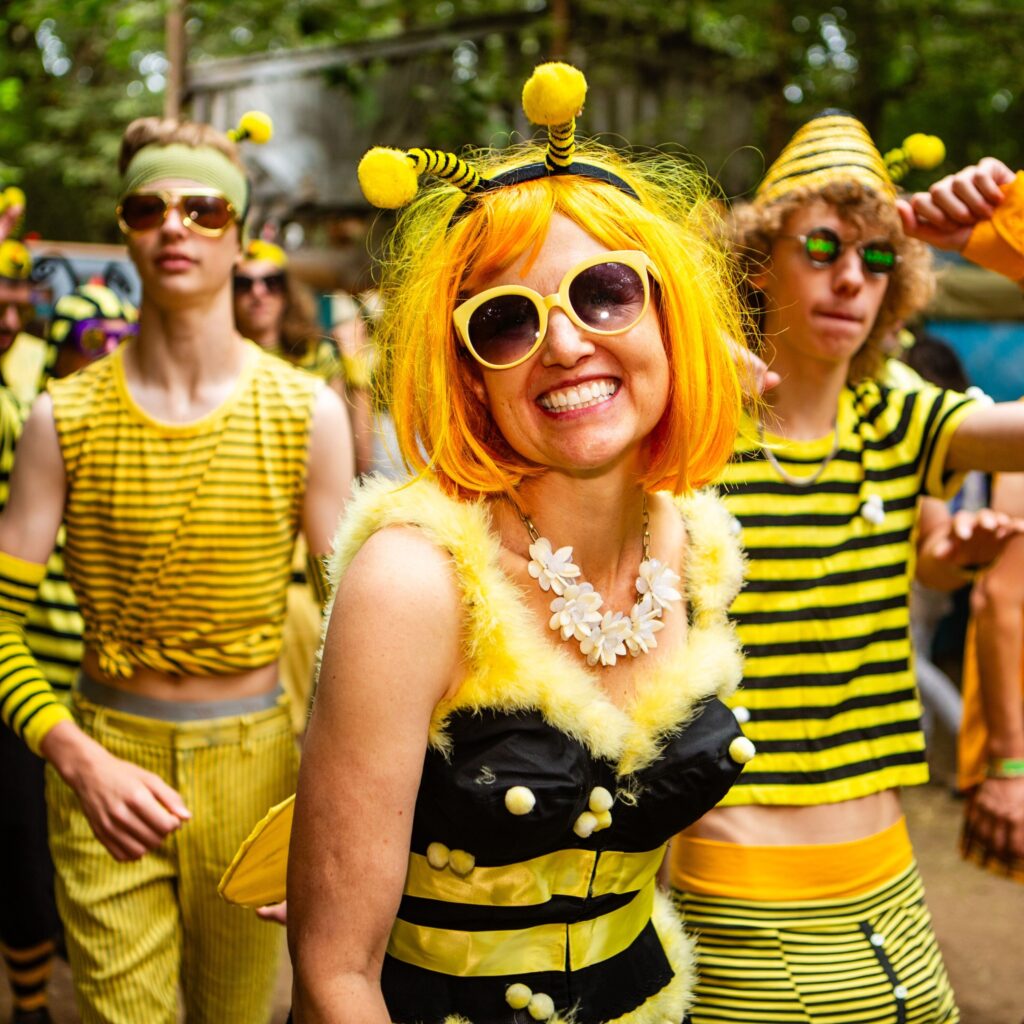 Three people dressed up as bumble bees.