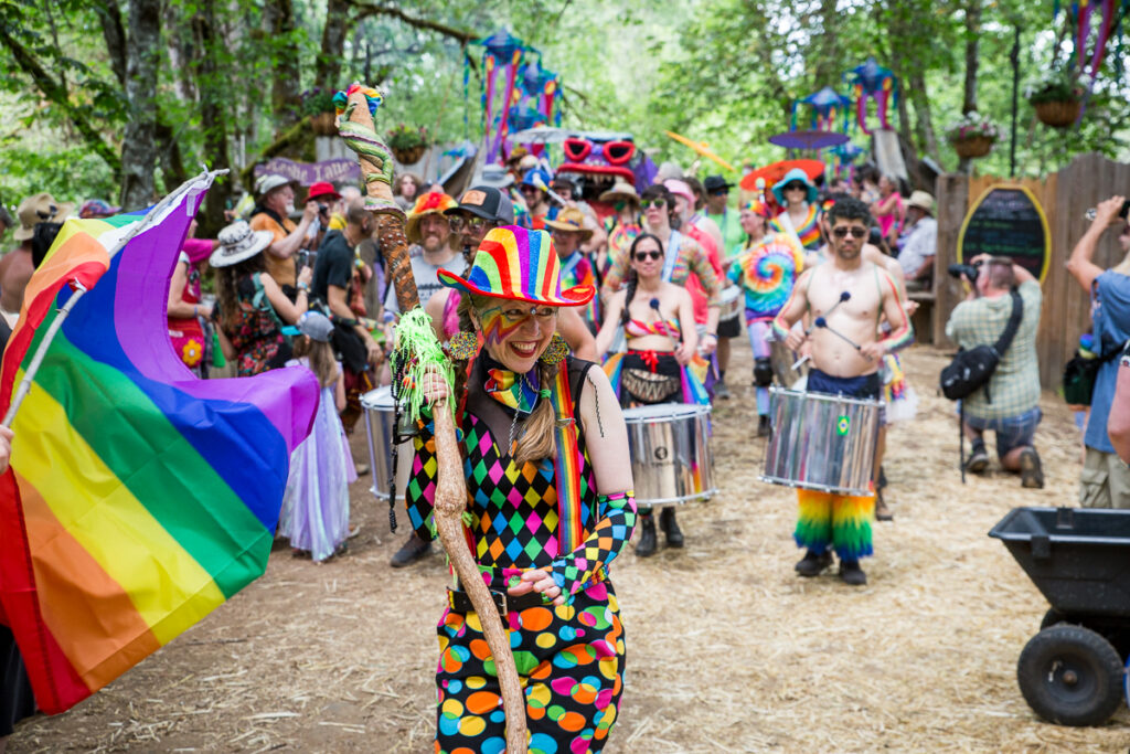 People parade down the street in colorful clothing.