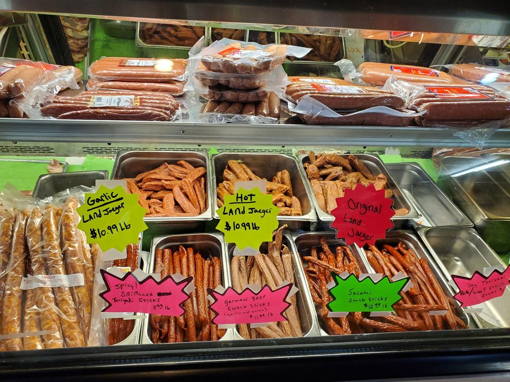 Tasty jerky and other meat in a glass display case.