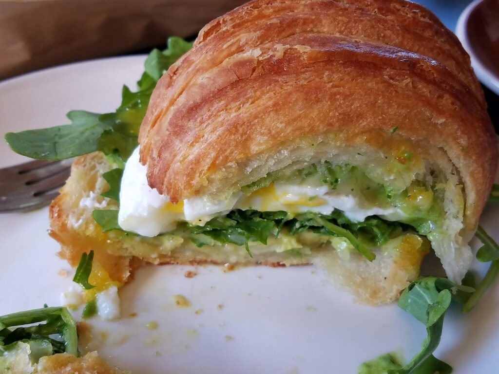 A delicious looking croissant sandwich.