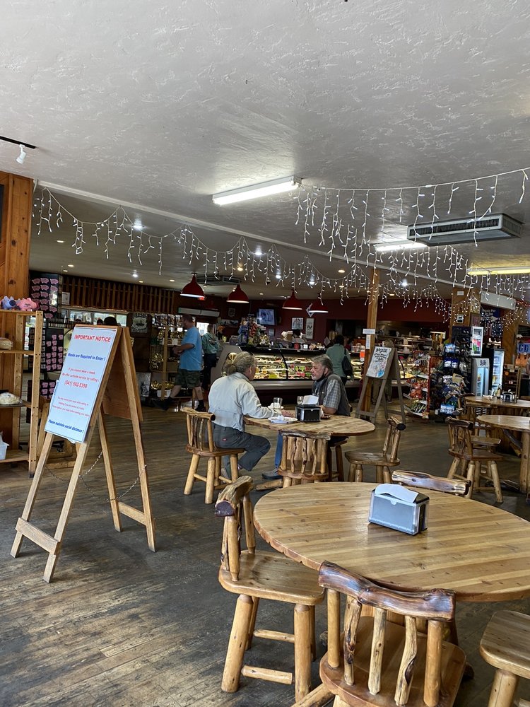 The cute interior of Taylor's Sausage Country Store. There are tables inside for eating.