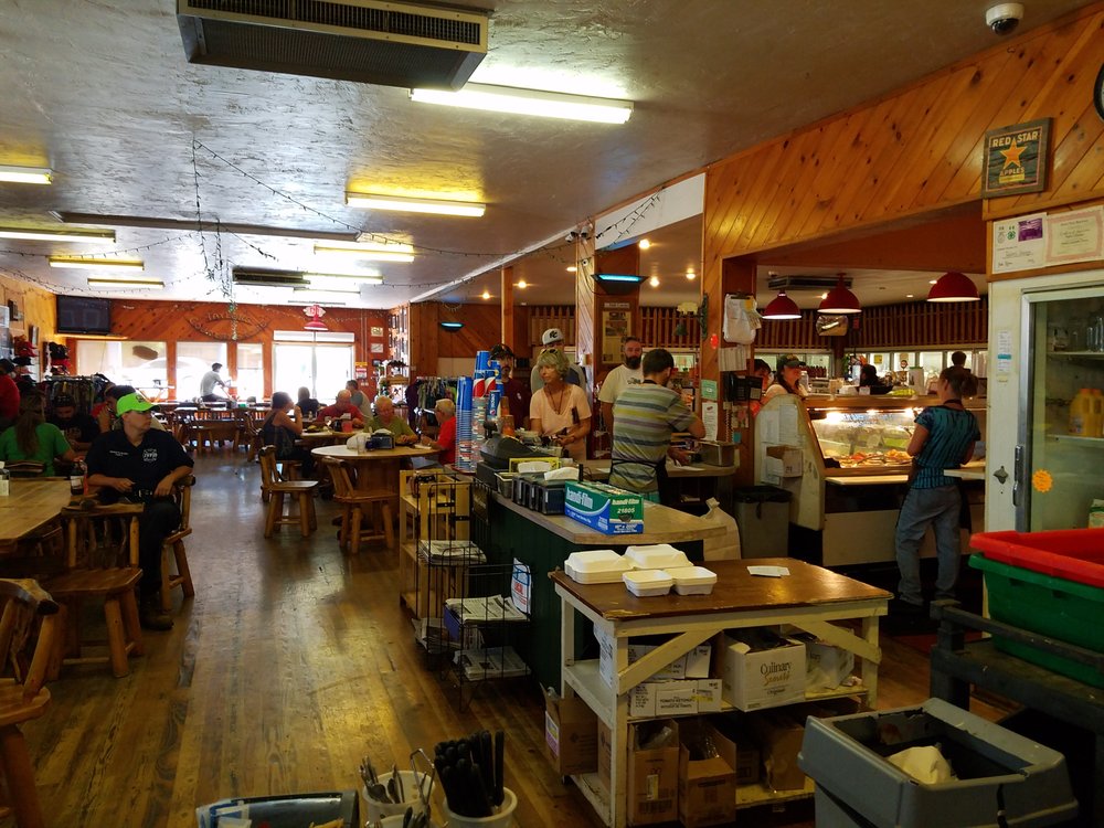 The cozy interior of Taylor's Sausage Country Store. It features warm wood tones.