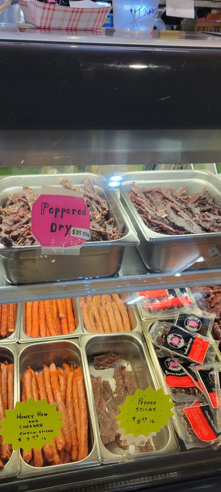 Tasty jerky and other meat in a glass display case.