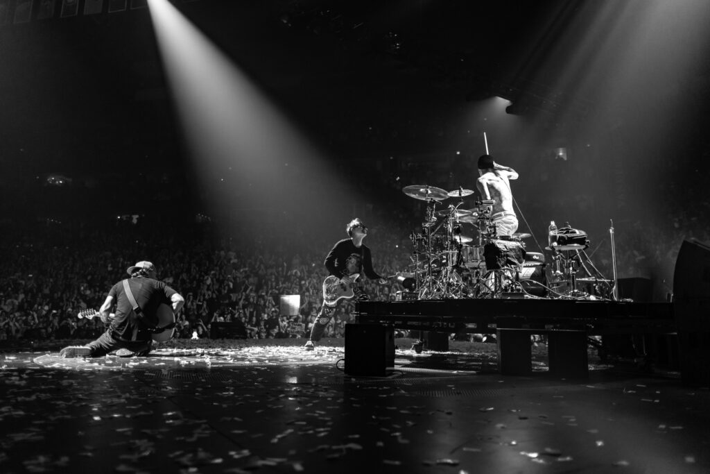 A black and white photo of Blink-182 performing on stage. Summer concerts, Oregon,  Things to do, 2024
