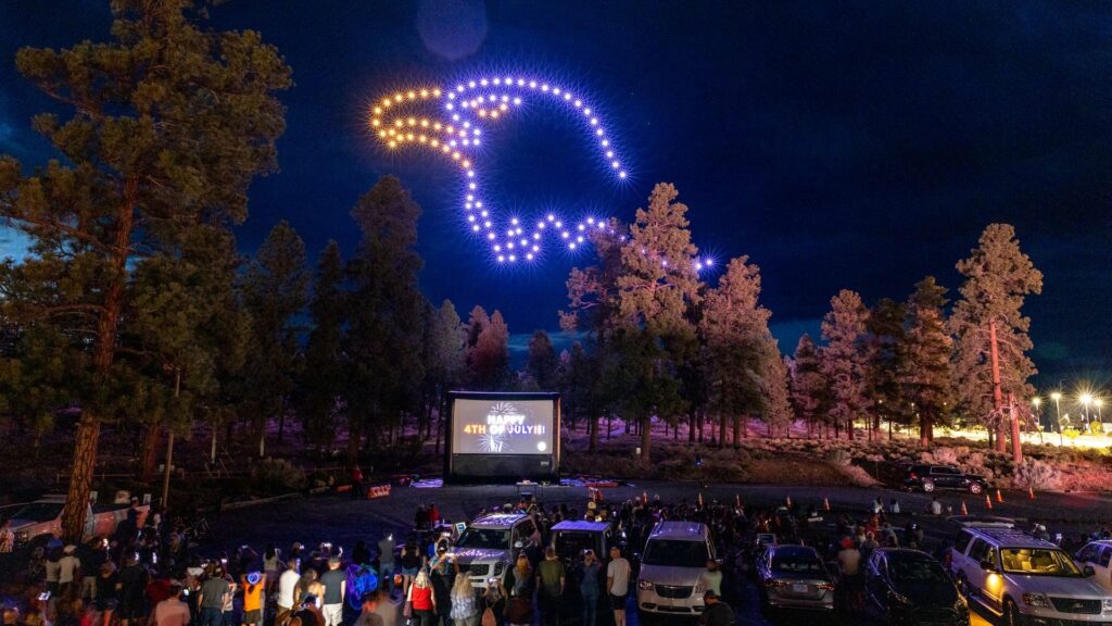 A giant eagle made up of drones in colors and yellow and blue.