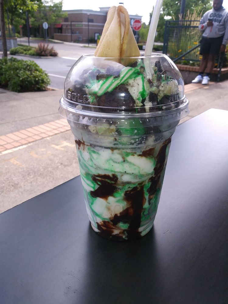 A tasty ice cream treat with green and white ice cream and toppings.