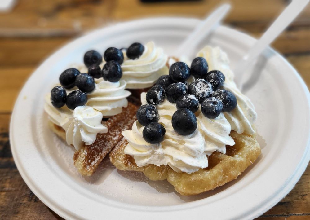 A hot croffle with toppings and blueberries.