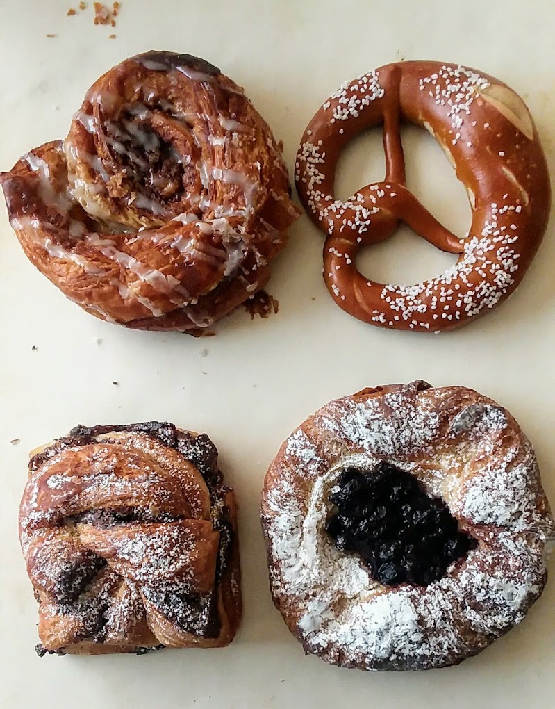 Three delicious looking German pastries, and a large soft pretzel from Fressen Bakery in Portland, Oregon.