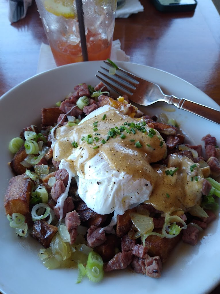 A plate of delicious looking breakfast food with eggs and meat.