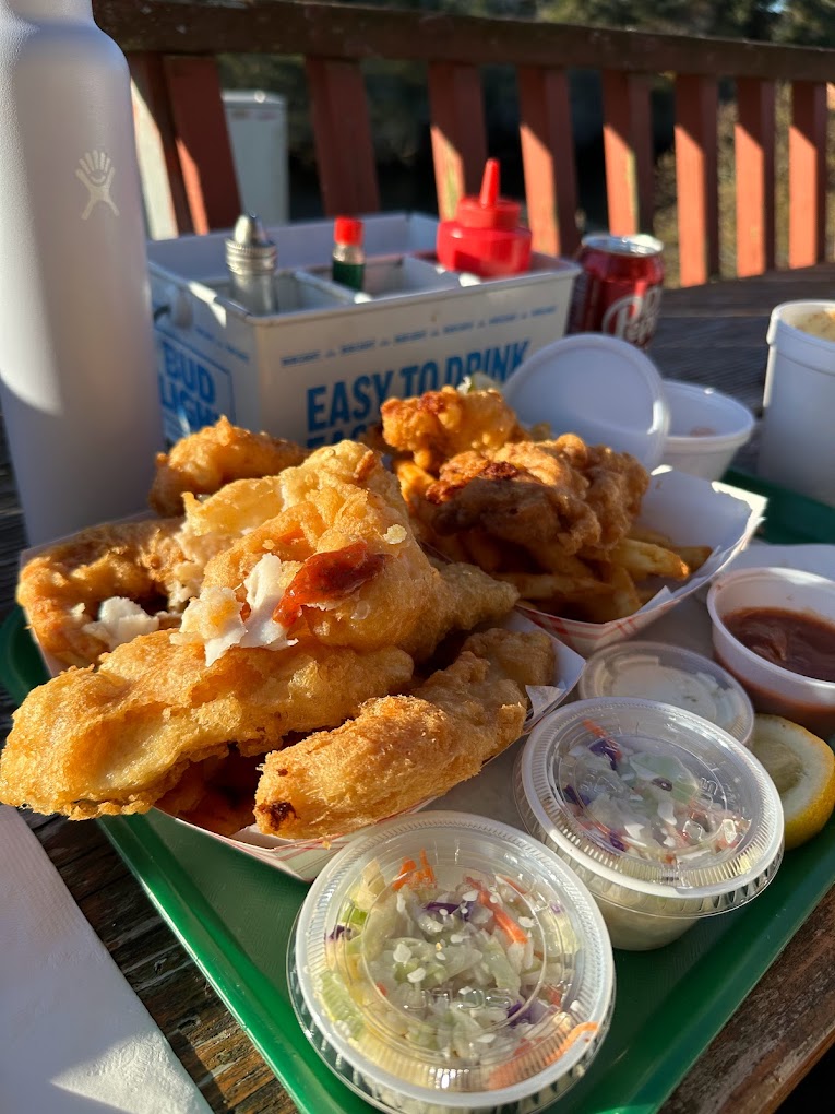 A tray full of fresh, crispy fried seafood and coleslaw.