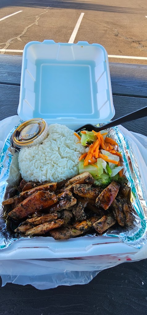 A white Styrofoam box filled with delicious looking Thai food.