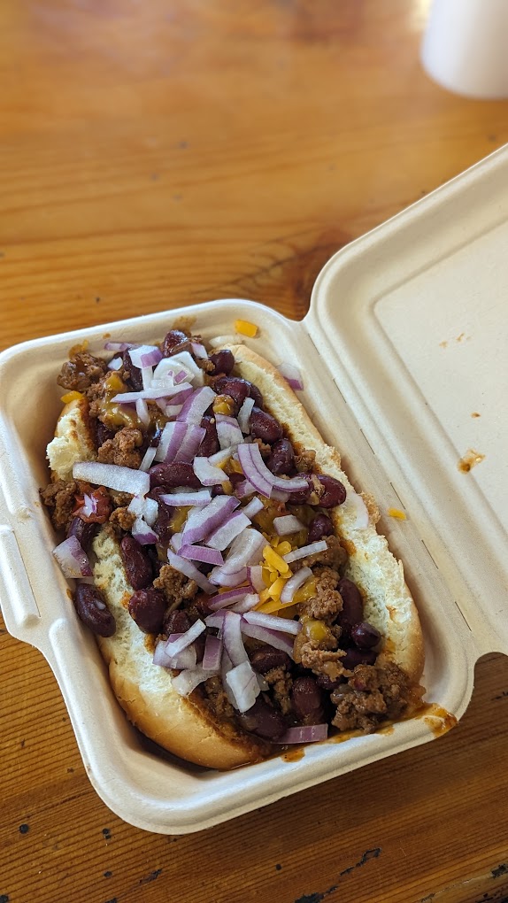 A chili dog with onions.