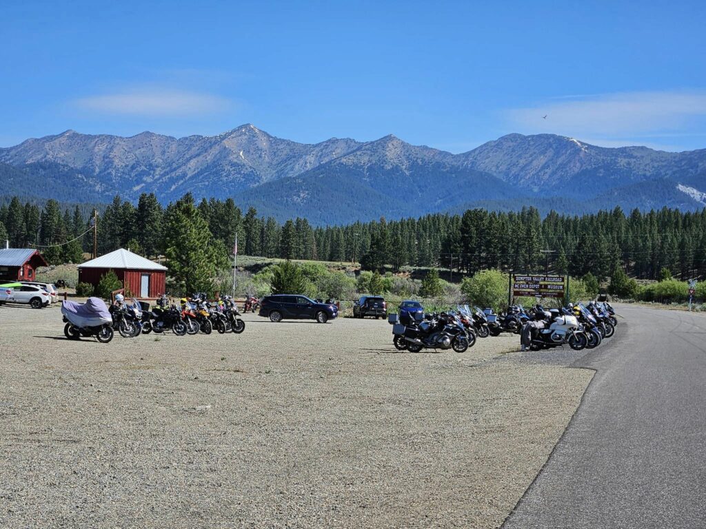 A view of mountains and the parking lot of a train station.