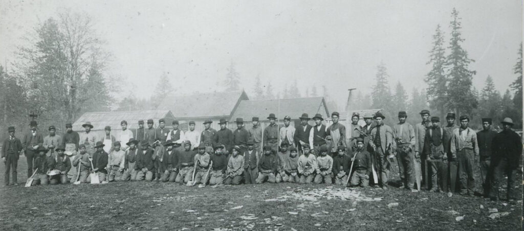 Ezra Woodward, his son Walter, and the students Woodward called his 'farmer boys.'
