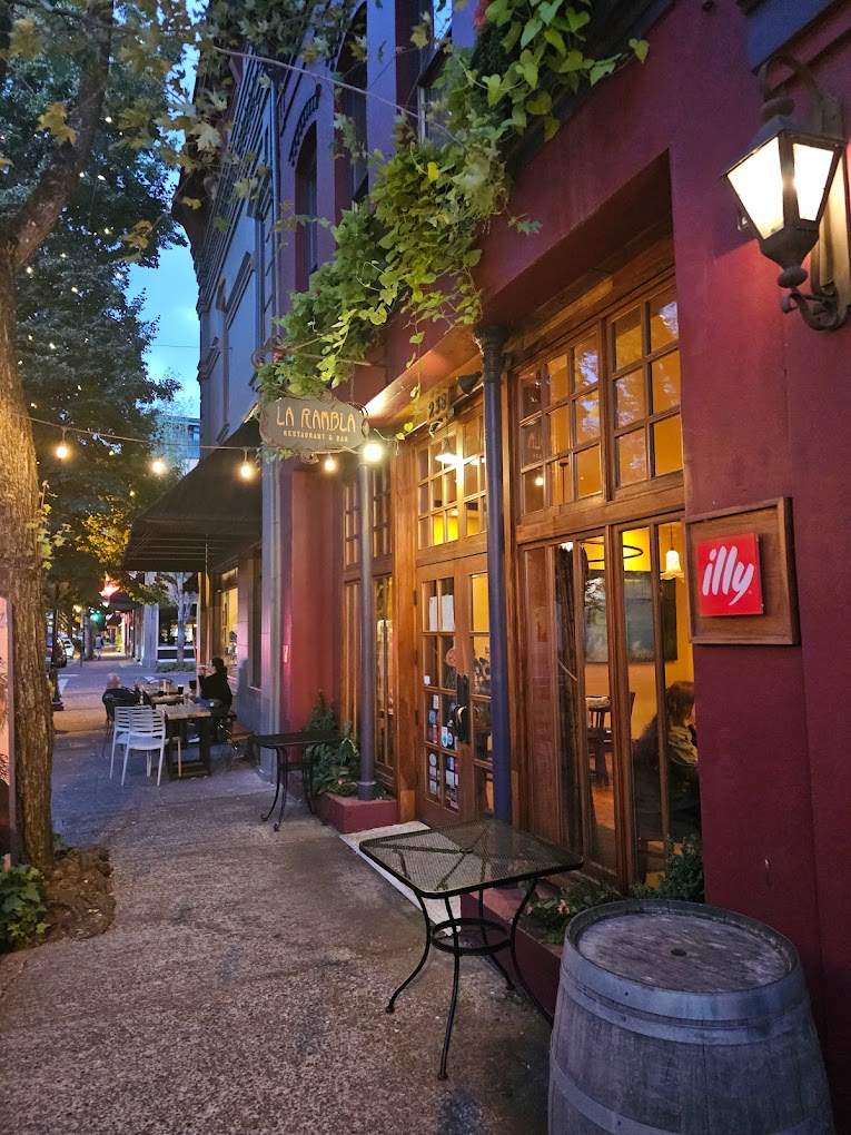 The outside of La Rambla. It's a pretty red brick building with red and dark blue accents.